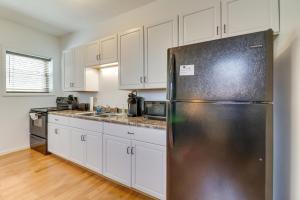 a kitchen with white cabinets and a stainless steel refrigerator at Marlinton Vacation Rental on Riverfront Trail! in Marlinton +18 photos