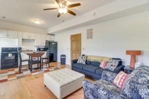 a living room with a blue couch and a kitchen at Cozy Marlinton Vacation Rental Downtown Location! in Marlinton
