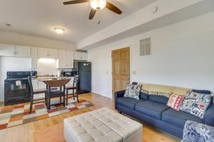 a living room with a blue couch and a kitchen at Cozy Marlinton Vacation Rental Downtown Location! in Marlinton +19 photos