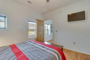 a bedroom with a bed and two windows at Cozy Marlinton Vacation Rental Downtown Location! in Marlinton