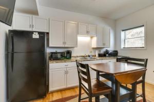 een keuken met een zwarte koelkast en een tafel bij Downtown Marlinton Vacation Rental Apartment! in Marlinton