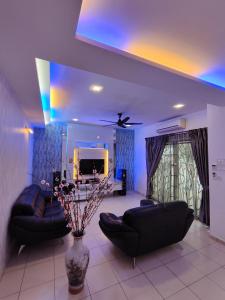a living room with black leather furniture and a ceiling at Ipoh Premium Cozy Relax Home in Ipoh