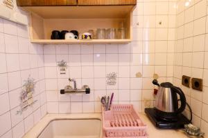 a kitchen counter with a sink and a tea pot at Save your money for travels stay here low cost. in Konak