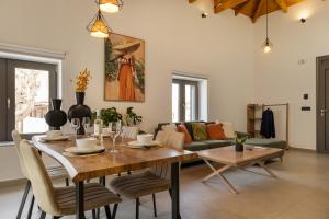 a living room with a table and a couch at Casa Dionysia - New Lux 2Br with Jacuzzi near Maleme Beach in Maleme