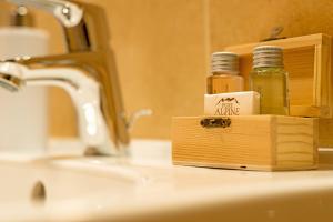 a bathroom sink with two bottles of essential oils at Le Alpi bed&living in Cividate Camuno