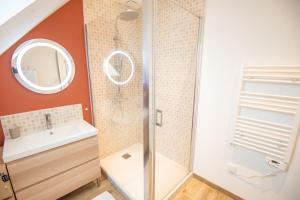 a bathroom with a shower and a sink and a mirror at Duplex tout confort - Gare TGV et hypercentre par Groom* in Lorient