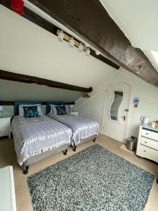 a bedroom with a bed and a rug at Rosegarth Guest House in Ravenglass