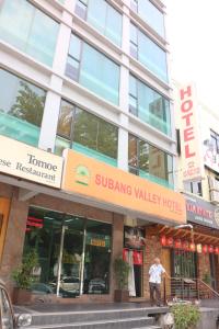 a man standing in front of a building at Subang Valley in Subang Jaya