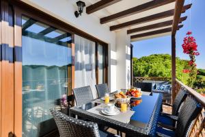 a table with a bowl of fruit on a balcony at Falesia Beach B in Albufeira