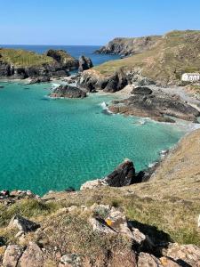 a large body of blue water on a rocky beach at Lizard ,Mullion holiday caravan in Mullion