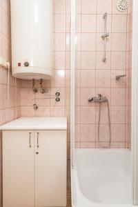 a bathroom with a white sink and a shower at Apartament Dolne Krupowki in Zakopane