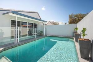 a swimming pool in the backyard of a house at Mooloolaba Escape to Mooloolaba & Feel At Home in Style in Mooloolaba