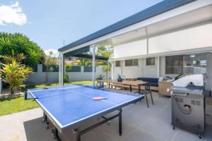 a ping pong table in the middle of a patio at Mooloolaba Escape to Mooloolaba & Feel At Home in Style in Mooloolaba