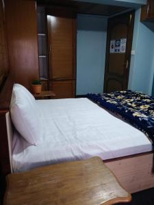 a bedroom with a large white bed in a room at Divine Bliss Homestay in Darjeeling