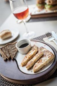 a plate with three pieces of bread and a glass of wine at Sotavento Beach Club in Costa Calma