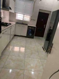 a kitchen with a washing machine in the middle at Jilles apartments -4bedroomduplex24hrlight&security in Lekki