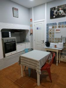 a kitchen with a table and a kitchen with a stove at Great Stay Fanqueiros Guest House 3 in Lisbon