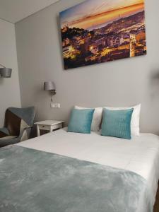 1 dormitorio con 1 cama blanca grande con almohadas azules en Great Stay Fanqueiros Guest House 3, en Lisboa