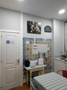 a room with a table and a kitchen with a door at Great Stay Fanqueiros Guest House 3 in Lisbon