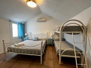 a bedroom with two bunk beds and a ladder at Camping Car Palmasera in Cala Gonone