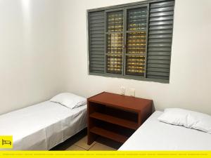 Uma cama ou camas num quarto em I9 CT - Casa de Temporada Empresarial - Agrishow