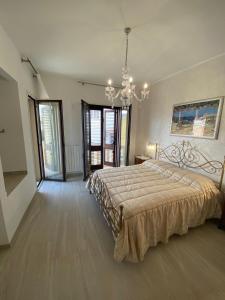 a large bedroom with a large bed and a chandelier at Romantica in Brindisi