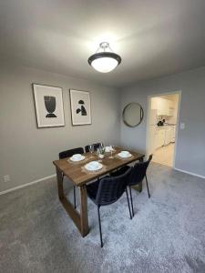 a dining room with a wooden table and chairs at Privacy and Exclusivity Condo at Crystal City With Gym in Arlington