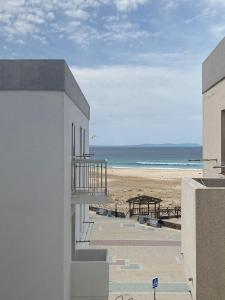 a view of the beach from the balcony of a building at Tarifabeach in Tarifa