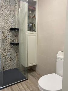 a bathroom with a toilet and a glass shower at Tarifabeach in Tarifa +14 photos