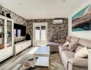 a living room with a couch and a tv at Tarifabeach in Tarifa
