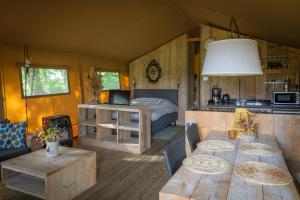 Zimmer mit einem Tisch und einem Bett sowie einer Küche in der Unterkunft Landrijk De Reesprong boerderij in Haaksbergen