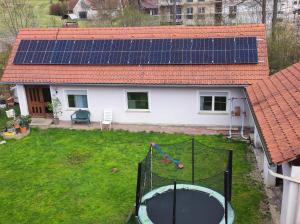 an image of a house with solar panels on the yard at Haus Jennifer in Hart bei Graz