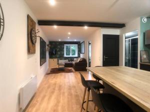 a living room with a large wooden table and chairs at Hello Bayeux #2 by Melrose in Bayeux