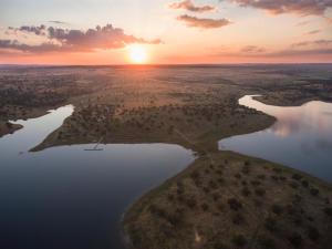 an aerial view of a river at sunset at Aladin Comfort Country Rooms in Campinho +28 photos