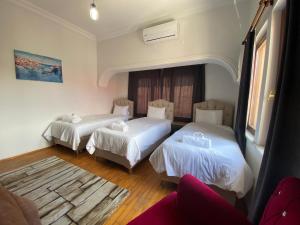 a hotel room with two beds and a couch at Ali Apart in Antalya