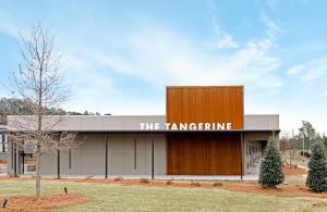 a building with a sign that reads the tangerine at The Tangerine Motel 