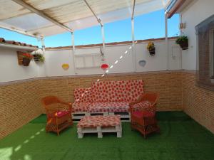 a room with a couch and chairs and a table at Reina Amalia in Quintanar de la Orden