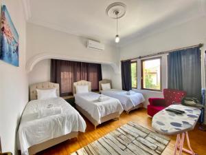 a hotel room with two beds and a couch at Ali Apart in Antalya +22 photos