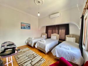 a hotel room with two beds and a couch at Ali Apart in Antalya