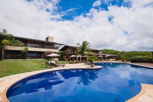 a large swimming pool in front of a building at Oka Da Mata in Pipa