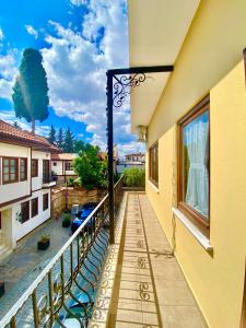 a balcony of a building with chairs and a window at Ali Apart in Antalya