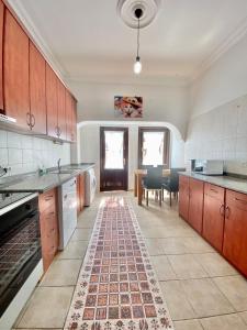 a large kitchen with a rug on the floor at Ali Apart in Antalya