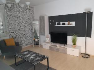 a living room with a flat screen tv on a wall at Landhaus Tirol in Lake Pressegg