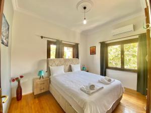 a bedroom with a bed with two towels on it at Ali Apart in Antalya