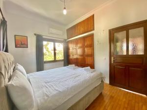 a bedroom with a white bed and a window at Ali Apart in Antalya