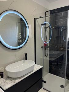 a bathroom with a sink and a mirror at Apartmani Rašić in Bibinje