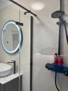 a bathroom with a shower with a mirror at Apartmani Rašić in Bibinje