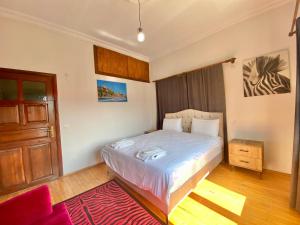 a bedroom with a bed and a wooden door at Ali Apart in Antalya