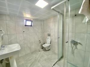 a bathroom with a shower and a toilet and a sink at Ali Apart in Antalya