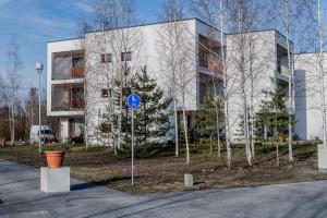 a building with a blue sign in front of it at Mesiheina Apartment in Pärnu